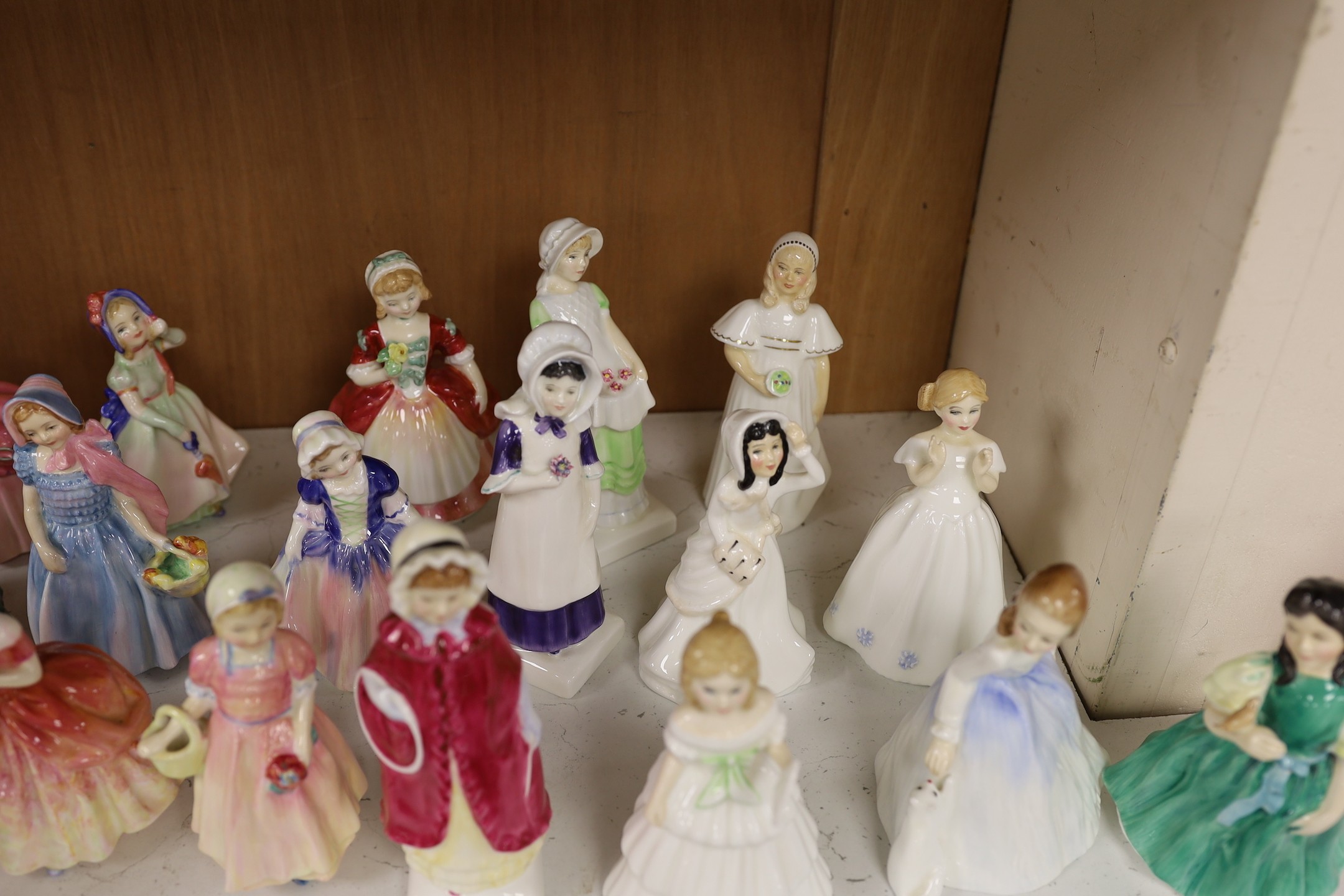 A collection of twenty five Royal Doulton figurines; Mandy, Penny, Ivy, the Rag Doll, Rose, Cissie, Tinkle Bell, Georgina, Julie, Andrea, Francine, Goody Two Shoes, Catherine, Helen, Anna, Dinky Do, Wendy, Belle, Marie,